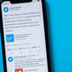 A phone with the Twitter statement regarding the suspension of Donald Trump's Twitter account.